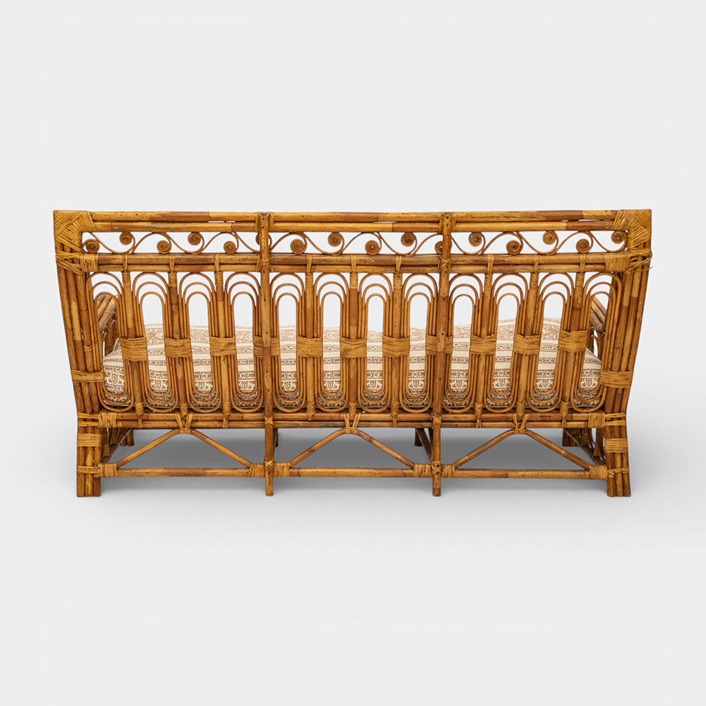 A Vintage French Rattan Sofa with Scroll Detail