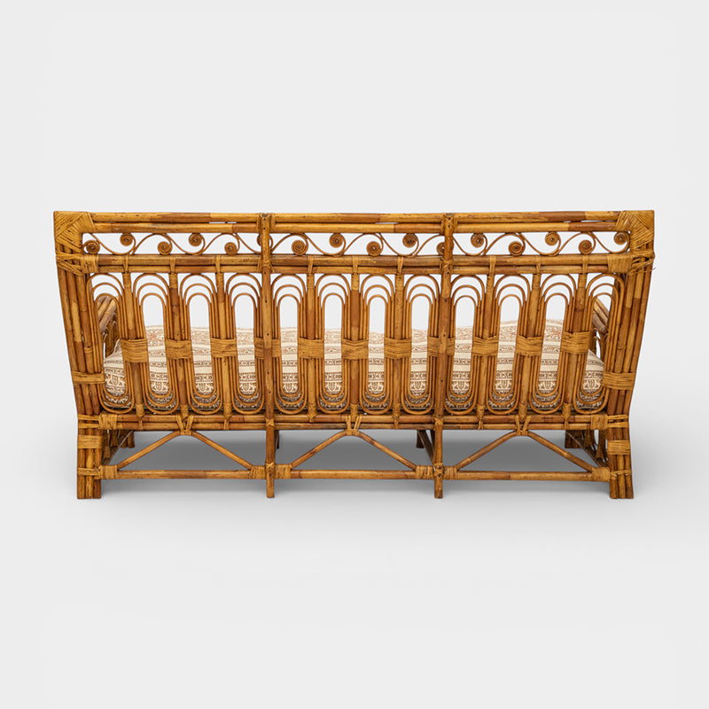 A Vintage French Rattan Sofa with Scroll Detail