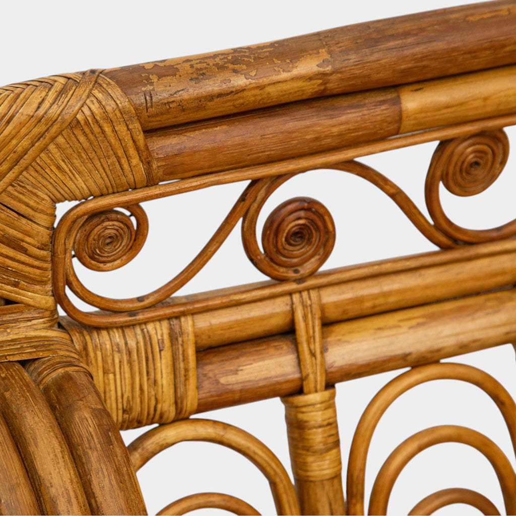 A Vintage French Rattan Sofa with Scroll Detail
