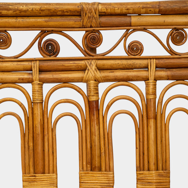 A Vintage French Rattan Sofa with Scroll Detail