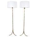 Pair of Faux Bamboo Two-Light Brass Standing Lamps with Tripod Feet in the Manner of Bagues