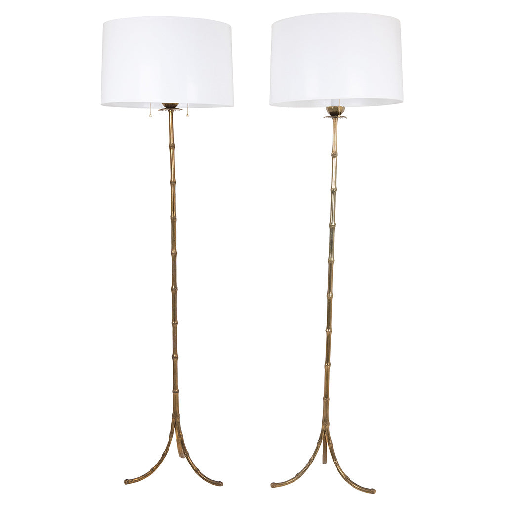 Pair of Faux Bamboo Two-Light Brass Standing Lamps with Tripod Feet in the Manner of Bagues