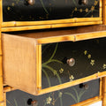 A Bamboo and Black Lacquered Chest with Hand Painted Floral Decor