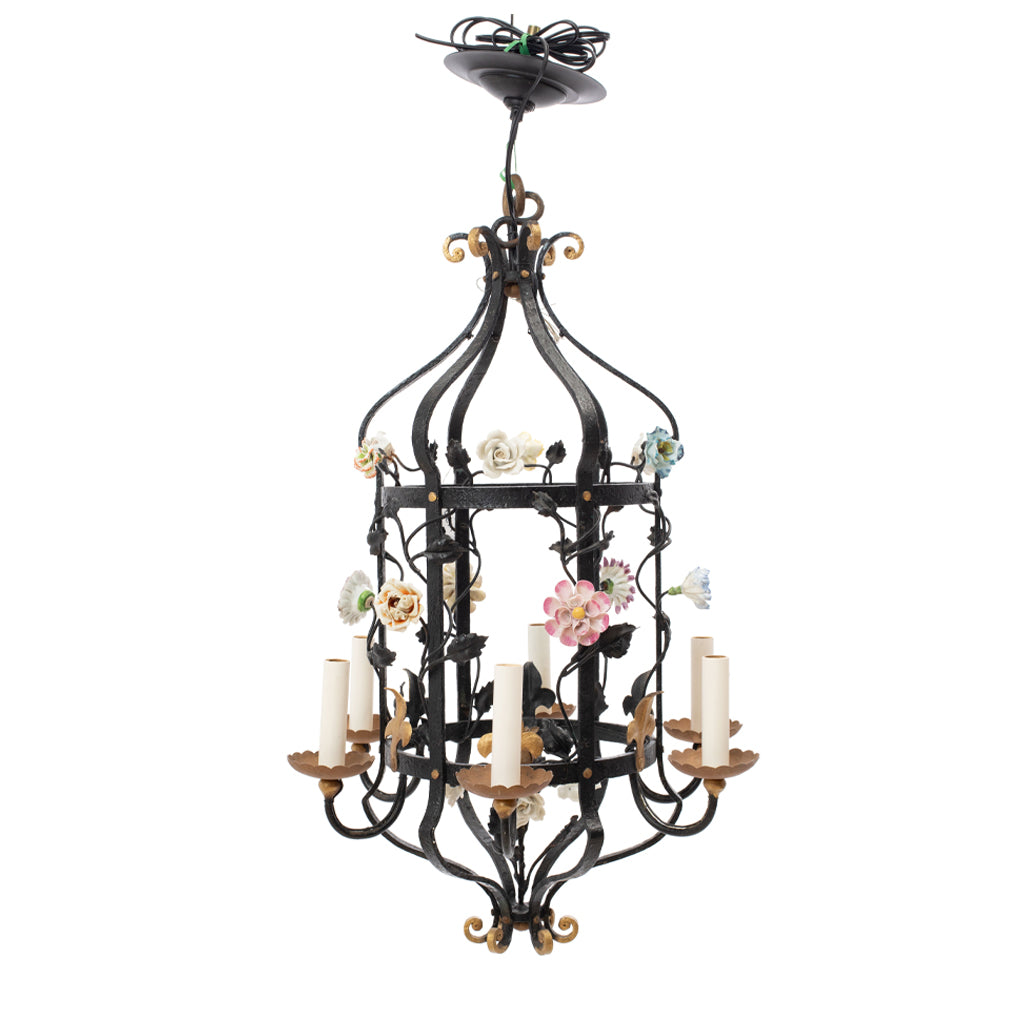 A Brass and Wrought Iron Chandelier with Painted Ceramic Flowers