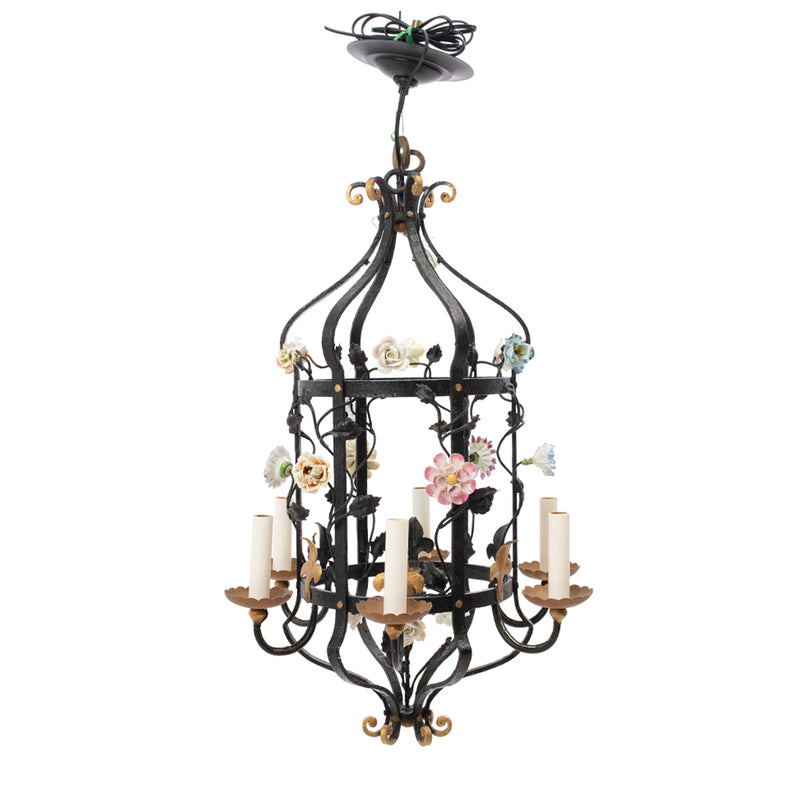 A Brass and Wrought Iron Chandelier with Painted Ceramic Flowers