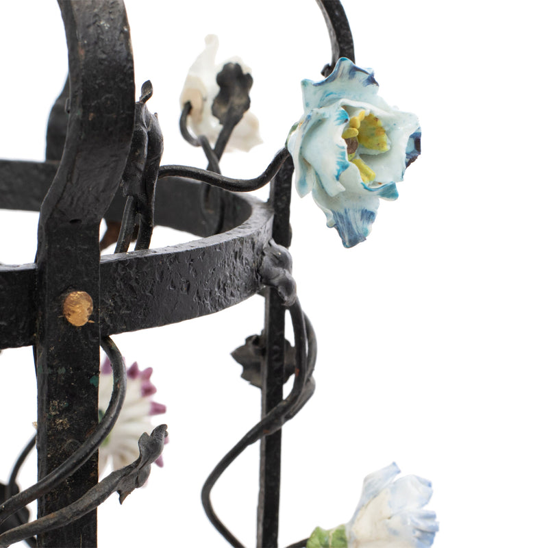 A Brass and Wrought Iron Chandelier with Painted Ceramic Flowers