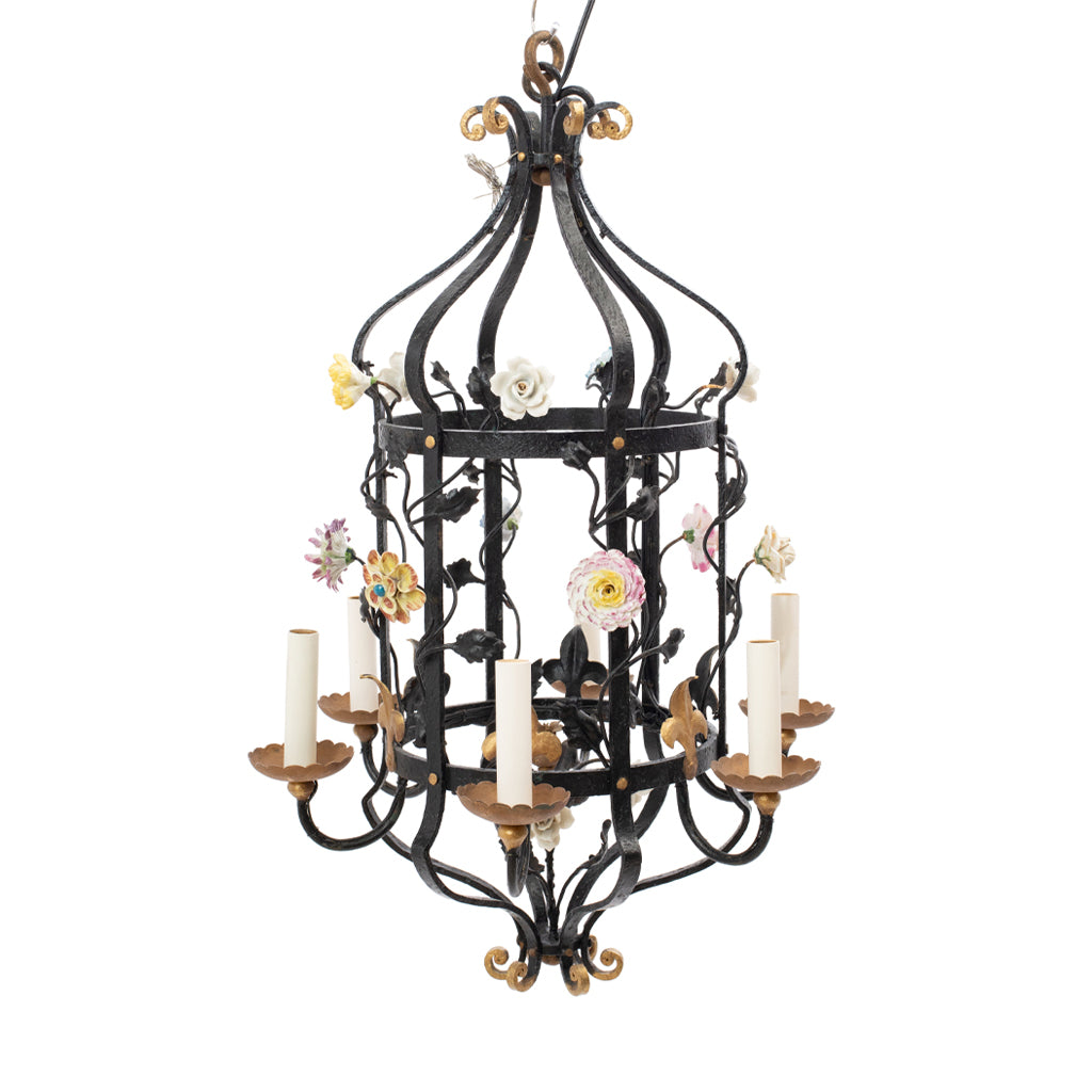 A Brass and Wrought Iron Chandelier with Painted Ceramic Flowers