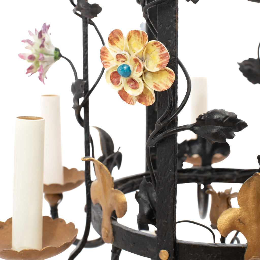 A Brass and Wrought Iron Chandelier with Painted Ceramic Flowers