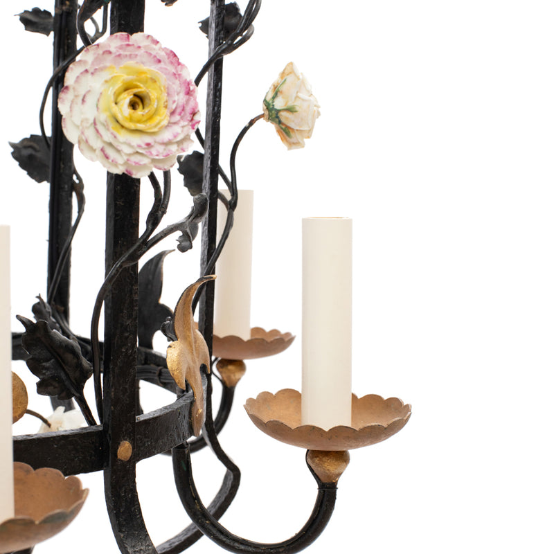 A Brass and Wrought Iron Chandelier with Painted Ceramic Flowers