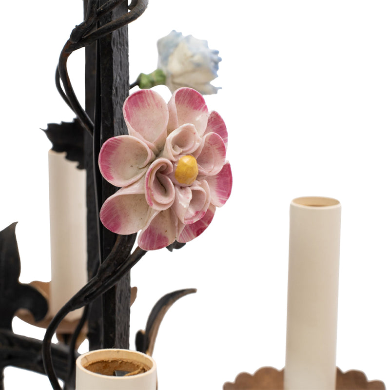 A Brass and Wrought Iron Chandelier with Painted Ceramic Flowers