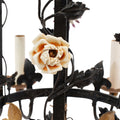 A Brass and Wrought Iron Chandelier with Painted Ceramic Flowers