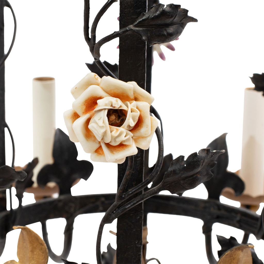 A Brass and Wrought Iron Chandelier with Painted Ceramic Flowers