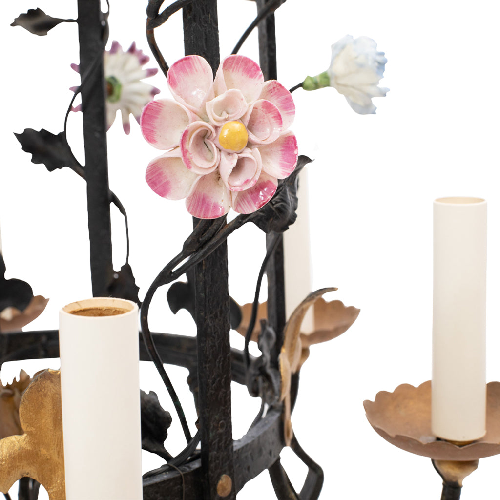 A Brass and Wrought Iron Chandelier with Painted Ceramic Flowers