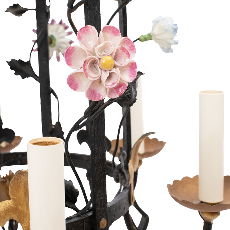 A Brass and Wrought Iron Chandelier with Painted Ceramic Flowers
